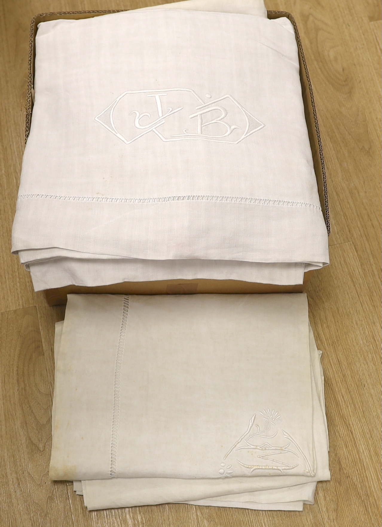 A collection of eight French provincial coarse linen sheets with embroidered and monogrammed turnbacks